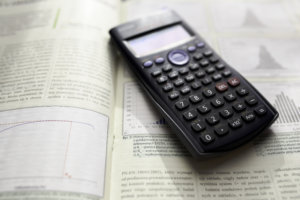Scientific calculator on top of an open textbook.
